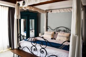 圣米格尔-德阿连德Mansion San Miguel的一间卧室配有天蓬床和镜子