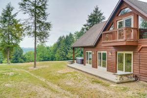 Benezette3-Acre Benezette Cabin with Hot Tub, Grill and Mtn View的木屋,设有甲板和房屋