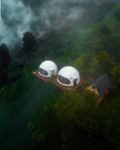 贾马里海姆森Bogina Dome & Suite - Çamlıhemşin的森林中间甲板上的两个圆顶