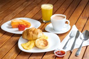 梅尔加Hotel Manantial Melgar Torre 2的两盘早餐食品和一杯咖啡