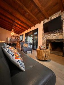马萨米特拉Cabaña El Encanto的带沙发和壁炉的客厅