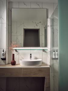拉加纳斯Anemelia Retreat的浴室设有白色水槽和镜子