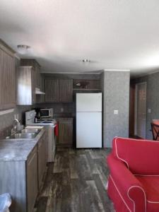 马布尔黑德Lake Point Motel的厨房配有白色冰箱和红色沙发