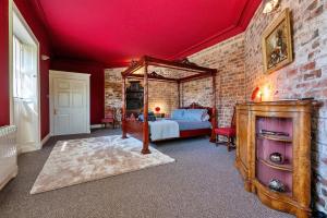 唐克斯特Finest Retreats - Hickleton Hall Estate的一间卧室设有一张床和砖墙