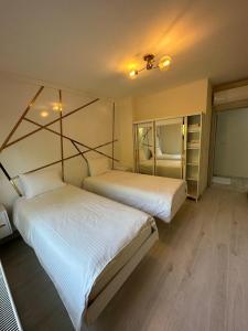 Nilüferبورصة شقة مريحة Bursa Nilufer مَنْظَرٌ جَمِيلٌ的配有白色床单的客房内的两张床
