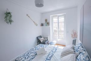 巴黎Paris Bercy - Charming Apartment 2 rooms的白色的卧室设有床和窗户