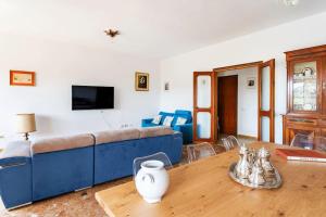 卡利亚里Casa San Saturnino appartamento 8 posti Cagliari centro的客厅配有蓝色的沙发和木桌