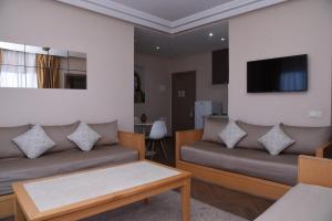 阿加迪尔金沙滩公寓酒店的客厅配有两张沙发和一台电视机