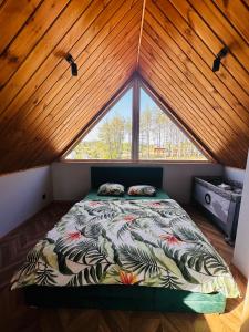 ŚliwiceBliżej Lasu的一张位于带大窗户的房间内的床铺