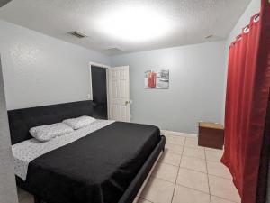 迈阿密MiLuSol的一间卧室配有床和红色窗帘
