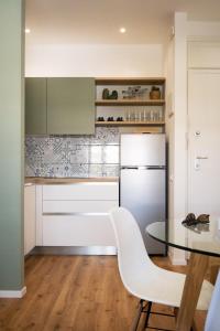 利多迪耶索罗Appartamento Nautilus的厨房配有桌子和白色冰箱。
