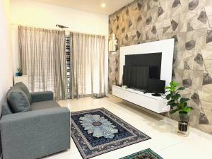 马六甲Alleysya's Homestay的客厅配有电视、沙发和电视。