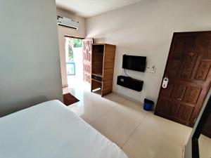 卡兰古特Calangute Turista的一间卧室配有一张床和一台平面电视