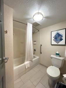印第安纳波利斯印第安纳波利斯市区医疗区烛木套房酒店的浴室配有卫生间、浴缸和水槽。