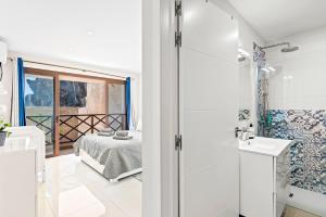 圣地亚哥港Duplex Ocean View Apartment in Neptuno的带淋浴的浴室和1间带1张床的卧室