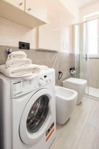萨莱诺Tenuta Croce Appartamento Karol-Piscina-Vista Mare的一间带洗衣机和卫生间的浴室