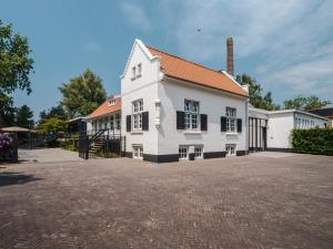 Sint-OedenrodeLindenhuys Logies的一座带砖瓦车道的大型白色房屋