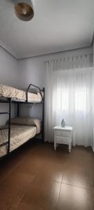 埃尔卡沃德加塔Mi Casita del Cabo的客房设有两张双层床和一张桌子。