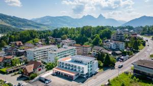 戈尔道Anstatthotel Goldau - self-check-in的城市的空中景观,背景是群山