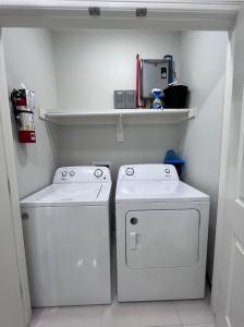爱丁堡Luxurious Modern Apartment #4的洗衣房配有2个白色洗衣机和1个架子