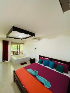 卡维塔Ocean View Lodge的一间卧室设有一张大床和一个浴缸