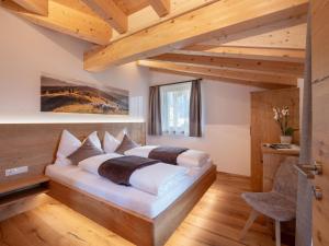 瑟尔Bauernhof Mühlbichl的一间带一张床的卧室,位于带木制天花板的房间内