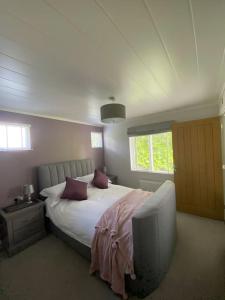 HartfordGorstage Meadows Luxury 2 Bedroom Lodge in Rural Cheshire的一间卧室配有一张床和一台电视