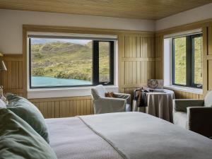 百内三塔Explora en Torres del Paine - All Inclusive的一间卧室设有一张床和一个大窗户
