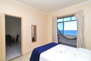 里约热内卢Rio Spot Homes vista praia D047的一间卧室设有一张床,享有海景