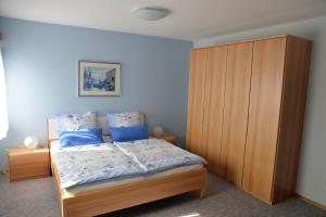 阿尔布斯塔特Ferienwohnung Dürnbach的一间卧室配有一张床和一个木制橱柜