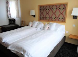 达沃斯邦德奈霍夫酒店的一张大白色的床,位于酒店客房内