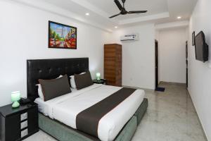 新德里Collection O Hotel Residency Near Dwarka Sector 21 Metro Station的一间卧室配有一张大床和吊扇