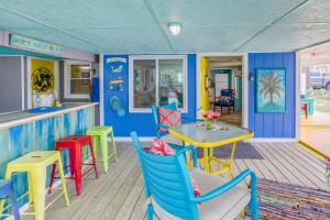 默特尔比奇Colorful Murrells Inlet Gem with Outdoor Space!的色彩缤纷的餐厅,配有桌椅