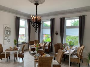 马兰迪Townhuus No. 1 / Dieksee的用餐室设有桌椅和窗户。
