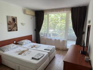布尔加斯Complex Nev的酒店客房设有两张床和窗户。