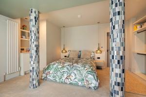 纽卡斯尔NEWCASTLE stunning sea views & forest backdrop的一间卧室配有一张床和两个高柱子