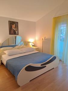 珀塞达耶Apartment Ema的一间卧室配有一张带蓝色毯子的大床