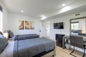洛杉矶Modern Apartment in Studio City的一间卧室配有两张床和一台平面电视