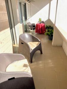达喀尔Appartement: Dakar-Plateau的一间设有椅子和一张红色桌子的房间