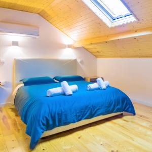 波尔图Porto Domus 210 Penthouse的一间卧室配有蓝色大床和蓝色枕头