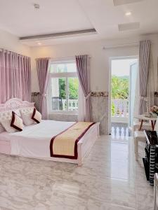 富国富国岛歌迪瓦酒店的白色卧室设有大床和窗户