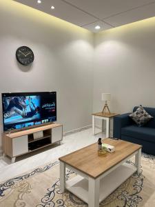 艾卜哈جناح فندقي في فله خاصة的客厅配有蓝色的沙发和电视