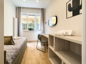 利多迪卡马约雷Versilia Residence - Fronte Mare的一间卧室配有一张床、一张桌子和一把椅子