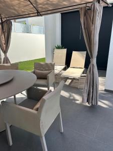 克萨达城Luxury Villa LAGUNA - Ciudad Quesada的庭院配有桌椅和桌椅