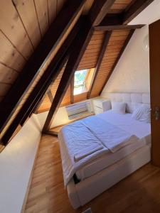 BolligenPrivate room for long term rent 1000-1200CHF per month的阁楼上的卧室配有一张大床