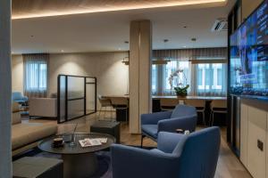 斯里巴加湾市汶萊酒店的客厅配有电视和蓝色椅子