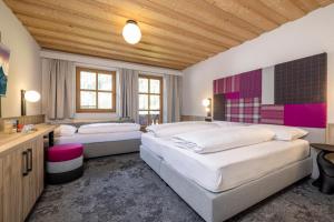 图克斯辛特图塞尔霍夫儿童与冰川酒店的一间卧室设有两张床和木制天花板