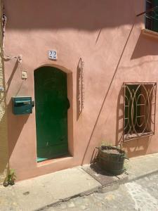 科利尤尔Petite maison quartier hist的粉红色建筑一侧的绿色门