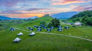 锡尔内亚Ursa Mica Glamping Resort的山丘上一组帐篷的空中景致