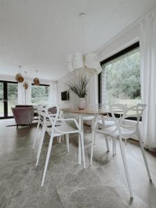 萨希诺希索伊扎卡特度假屋的白色的用餐室配有桌椅